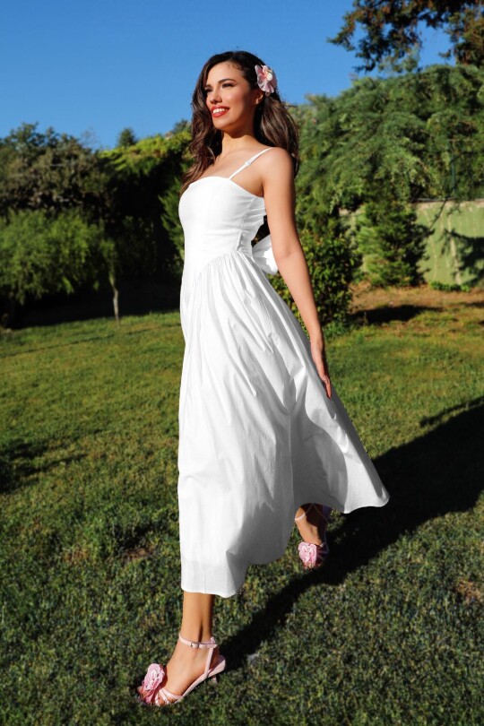White midi dress with open back and bow detail 